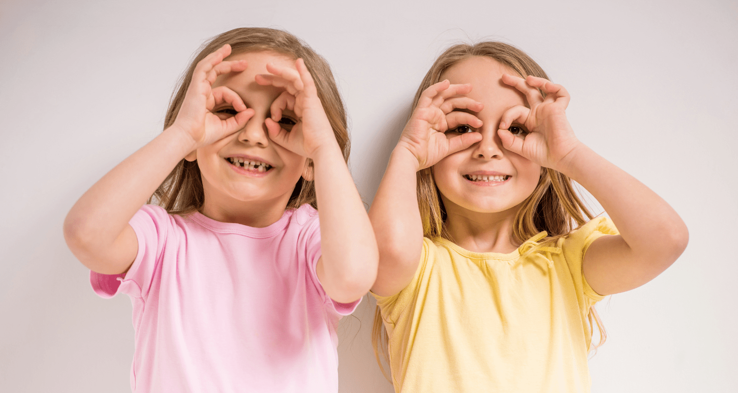 sisters looking through hands